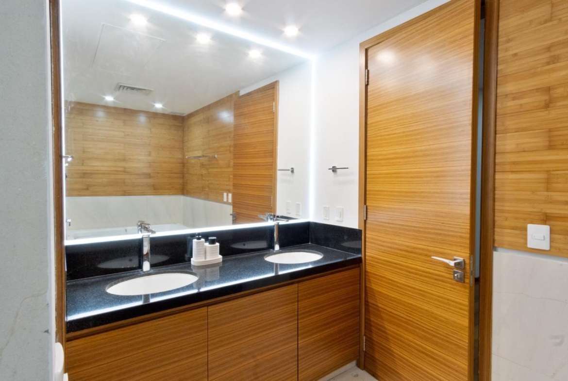 Vista del baño de una de las recámaras de una casa de lujo en venta en Puerto Cancún, con diseño moderno, increible iluminación y diseños de lujo.